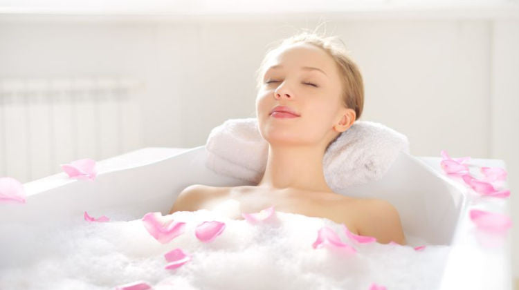 Woman enjoying the benefits of a hot bath